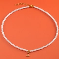 Elegant pearl necklace with 18K gold plated letter Z heart pendant on orange background - Letter Z (NK228ZP39270-2)