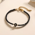Verstelbare zwarte kralenarmband met gouden letter X en kristallen facetkralen - Letter - X