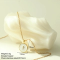 Close-up of a white round enamel pendant with a gold cross on a stainless steel chain - White Cross Style (MFNK024G10)