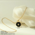 Detail of gold star black enamel pendant on stainless steel chain over white stone - Five-Pointed Star Style (MFNK024G7)