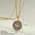 Macro shot of gold stainless steel necklace featuring a purple enamel bee pendant detail - Purple Round Bee Pendant (MFNK032G9)