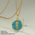 Macro shot of gold seahorse enamel pendant with copper and stainless steel chain details - Irregular Seahorse Round Pendant (MFNK032G3)