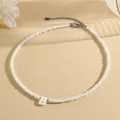 Witte gefacetteerde kralenketting met een schelp letter B hanger en stalen sluiting - B (SHNK2434)