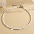 Minimalist white faceted beaded necklace featuring a shell letter J pendant and silver clasp - J (SHNK2434)