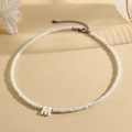 Elegant white beaded necklace featuring a white letter M pendant and adjustable chain - M (SHNK2434)