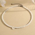 Beaded necklace with white letter O shell pendant and translucent faceted crystal beads - O (SHNK2434)