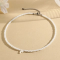 Elegant beaded necklace featuring a white shell-style letter P pendant and silver clasp - P (SHNK2434)