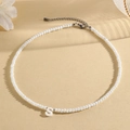 Elegant beaded necklace with white faceted beads and letter S pendant in a minimalist setup - S (SHNK2434)