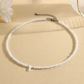 White beaded necklace featuring a letter T pendant with faceted beads and silver clasp - T (SHNK2434)