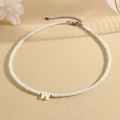 Minimalist white beaded necklace with a letter W pendant and gold-tone lobster clasp - W (SHNK2434)