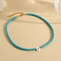 Beaded turquoise necklace featuring a white shell letter O pendant and gold clasp - O (SHNK2435)