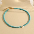 Blue turquoise beaded necklace with white letter Q pendant and gold clasp detail - Q (SHNK2435)