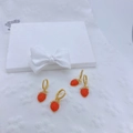 Detail of red strawberry earrings with gold hoops and sparkling cubic zirconia stones - Earrings