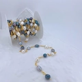 Macro detail of handmade baroque pearl chain roll with gold wire for jewelry making - Multicolor Pearl-Gold Chain