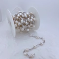 Macro detail of freshwater baroque pearl chain with cubic zirconia accents on spool - White Pearl-Silver Chain