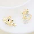 Detail of two-tone gold and silver layered flower rings on a white porcelain dish - Layered Floral Style (#3)