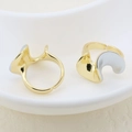 Detailed view of minimalist gold and silver wavy adjustable open rings on a ceramic plate - Streamlined Pleated Style (#2)