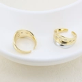 Close-up of dual-tone gold-plated open rings with inlaid white zircons in a ceramic dish - Pitted Texture Rhinestone Style (#11)