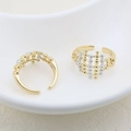 Macro detail of two-tone geometric mesh rings in gold and silver finish on white tray - Geometric Grid Style (#4)