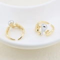 Detailed shot of irregular gold rings with silver pearls on a white ceramic plate - Irregular Flow Design (#2)