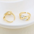 Detail of adjustable chain-link rings in gold and silver finish on white ceramic plate - Chain Design (#1)