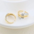 Detail view of two-tone gold and silver irregular layered open rings in a ceramic dish - Multi-layer Wave Design (#11)