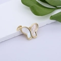 Macro detail of gold-plated butterfly pendant with white shell wings on white stone - Gold Simple Butterfly (MLDZ-3-7)