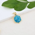 Detailed macro view of a gold-plated sea turtle pendant with vibrant blue enamel inlay - Blue Gold Sea Turtle Pendant (#14)