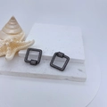 Macro view of square black alloy screw clasp accessory with pavé cubic zirconia - Black White