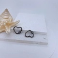 Macro detail of heart-shaped black metal screw clasps with micro-set zircon accents - Gun Black Plated Clear Zirconia Style