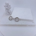 Elegant silver pave hoop earrings with clear cubic zirconia on minimalist stone background - Silver Ring Style