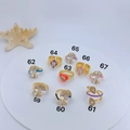 Macro shot of assorted colorful enamel evil eye rings with cubic zirconia inlays - Enamel Heart Geometric Style (59)