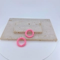 Pink round copper spring rings for DIY jewelry and keychain accessories on stone - Pink