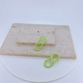Detail of neon green S-shaped carabiners in matte finish on a stone texture base - Neon Green