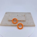 Two orange round spring ring buckles on travertine stones for DIY jewelry making - Orange
