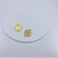 Golden heart-shaped pendant with zircons and sunburst pattern on a white tray - Evil Eye Heart Style (#4)