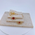 Golden Evil Eye jewelry set with red stones and zircon pavé on a beige travertine base - Red Evil Eye Style Gold (Pendant Only)