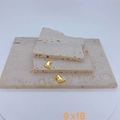 Detail of gold-plated feet pendants 9x18mm displayed on textured beige stone surface - Gold Footprint Style (#8 Pendant Only (Without Chain))