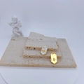Macro shot of hexagon bee pendant with white enamel inlay and gold lunar detail - White