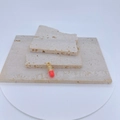 Detailed view of red capsule pendant with zircon micro-pave on a natural stone background - Bright Red Style (ML)