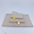 Detailed view of bear-shaped gold pendants with yellow enamel and white heart on stone - Yellow
