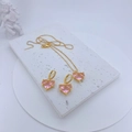 Detail shot of heart-shaped pink zircon jewelry set on white marble with angel decor - Plum Pink Zirconia Jewelry Set