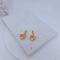 Detail of gold-plated heart earrings with pink zircon stones on marble display - Earrings Only (Without Necklace) (Plum Pink)