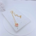 Close-up of a gold necklace with pink heart-shaped crystal on white stone - Necklace Only (Without Earrings) (Plum Pink)