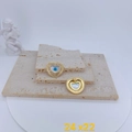 Detail of heart-shaped evil eye pendants with mother of pearl and zircon pavé in gold - Large Heart Shell Eye Style