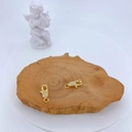 Gold plated lobster clasps with micro-pave cubic zirconia on natural wood background - Gold with White Zirconia