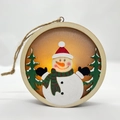 Hanging wooden Christmas lantern with glowing LED snowman and winter tree scene inside - Snowman