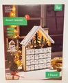 White wooden advent calendar house with 24 drawers, LED silhouette, and 6-hour timer - White House Style