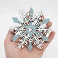 Blue and white wooden snowflake ornament with star cutout and rustic jute rope - Grey Blue Snowflake Style