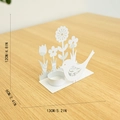 White metal Easter candle holder with cutout bird and flower design on wooden surface - Bird Candle Holder